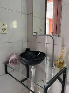 a bathroom with a black sink and a mirror at Cores da pipa flats in Pipa +45 photos