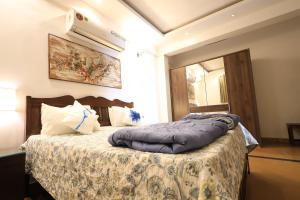 ein Schlafzimmer mit einem Bett mit einer Bettdecke darauf in der Unterkunft Villa Nazuri w Caretaker in Candolim + 19 Fotos