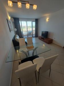 a living room with a glass table and chairs at Lozenets Oasis Beach Home Lila in Lozenets