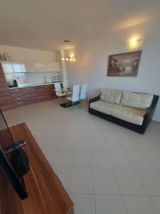 a living room with a couch and a table at Lozenets Oasis Beach Home Lila in Lozenets