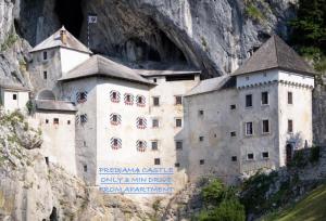 a building on the side of a mountain at Studio apartment in nature with sauna in Postojna +6 photos