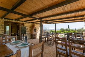 a restaurant with tables and chairs with a view at Agriturismo Villa Paradisino MUSICO in Montalcino