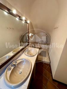 a bathroom with two sinks and a large mirror at La Torre "UnaNotteaCasaMia" in Sacrofano +37 photos