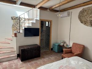 a living room with a staircase and a chair at Antica Dimora Vaglica in Palermo