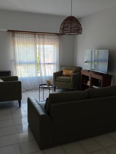 a living room with two couches and a table at Apartamento El Cerrito in Tandil