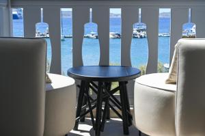 a table in a room with a view of the water at ASTREA Relax Suites in Adamantas