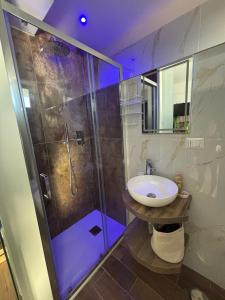 a bathroom with a glass shower and a sink at Confini Retreat in Minturno +12 photos