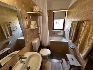 a bathroom with a sink and a toilet and a tub at Villa Kate in Vis +25 photos