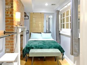 a bedroom with a bed with a green blanket at Corporate Housing, Upgraded Condo Downtown Hoboken in Hoboken