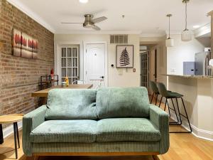 a living room with a couch and a kitchen at Corporate Housing, Upgraded Condo Downtown Hoboken in Hoboken
