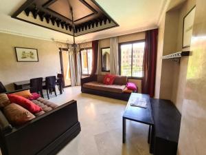 a living room with a couch and a table at Palm river marrackech in Marrakesh