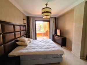 a bedroom with a large bed and a window at Palm river marrackech in Marrakesh