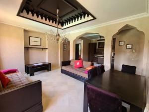 a living room with a couch and a table at Palm river marrackech in Marrakesh