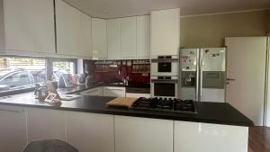 a kitchen with white cabinets and stainless steel appliances at FREIraum14 in Oldenburg +6 photos