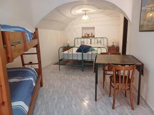 a room with a bed and a table and chairs at Casa delle Sirene e del Polpo in Bosa +13 photos