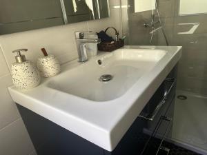 a white sink in a bathroom with a mirror at La Maison du Rond-Buisson in Maîche +15 photos
