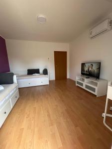 a large living room with a flat screen tv at Apartment Kix in Rab