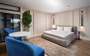 a bedroom with a bed and a table and chairs at Walton Gardens Pera in Istanbul