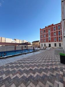 a view of the courtyard of a building with a pool at Royal resort in Aktau