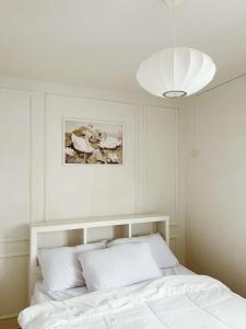 a white bedroom with a bed and a white ceiling at Maison de Jacinta - 2BR HOUSE NEAR AGUINALDO HIGHWAY in Dasmariñas +14 photos