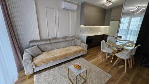 a living room with a couch and a table at RentiStok - Apartament w Centrum in Białystok