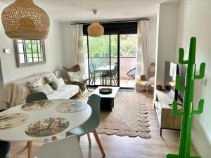a living room with a table and a couch at Brisa Marela in Sanxenxo