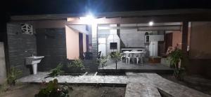 a house with a kitchen and a patio at night at A Casa TOP da Região in Matinhos