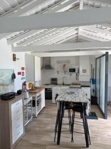 a kitchen with a table in the middle of a room at Moradia Terra Chã Sea View 1 to 4 pers in Lomba +25 photos