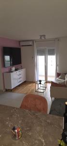 a living room with a couch and a table at Split/Podstrana Apartment ADRIA in Podstrana