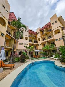 a swimming pool in front of a building at Pipas Apartment I Walk to the beach in Tamarindo