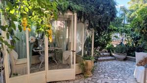 a garden entrance to a greenhouse with plants at Relais L'Eucalipto in Sant'Agata de' Goti