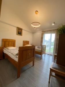 a bedroom with a bed and a table and a window at Family house in Valmiera +6 photos