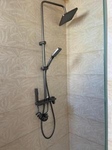 a shower with a shower head on a wall at City centro 5th Floor sin ascensor No Lift Long time good price in Valencia +4 photos