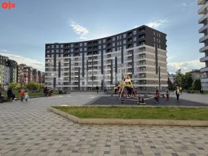 a large building with a playground in front of it at Luxury Apartment Tuzla Stupine in Ši Selo