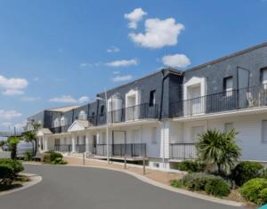 a row of apartment buildings on a street at Appartement Grande Plage St Gilles Croix de Vie - Parking privé in Saint-Gilles-Croix-de-Vie