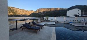 a house with a swimming pool and mountains in the background at Harmony House - Adults Only in Dubova