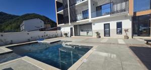 a swimming pool in front of a building at Harmony House - Adults Only in Dubova