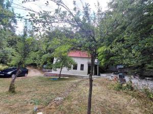 a house with a car parked in front of it at Kuća na selu in Šavnik