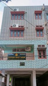 a building with a sign on the front of it at Eksringa Guest House in Guwahati +4 photos