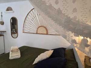 a bedroom with a green bed and a staircase at Studio Arènes Congrès EcoFriendly Centre in Nîmes