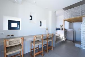 a dining room with a table and chairs at ANOTERRA VILLAS -Astris in Ambelas