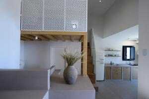 a kitchen with a vase sitting on a table at ANOTERRA VILLAS -Astris in Ambelas