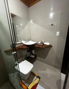 a bathroom with a toilet and a sink at Casa da Figueira in Louro Müller +17 photos
