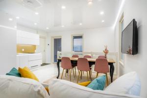 a kitchen and dining room with a table and chairs at Modern apartment with jacuzzi and sauna in Vaasa