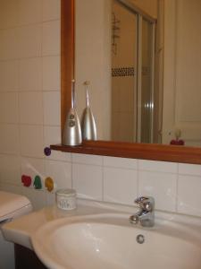La salle de bains est pourvue d'un lavabo blanc et d'un miroir. dans l'établissement city-break, à Épinal