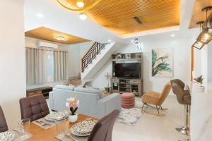a living room with a blue couch and a table at CasaPrincesa near Honda Bay Island in Puerto Princesa City