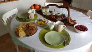 a table with a white table cloth with food on it at Le Clos des Laurons in Nyons