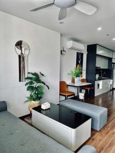 a living room with a couch and a table at Green Diamon Luxury Apartment in Ha Long