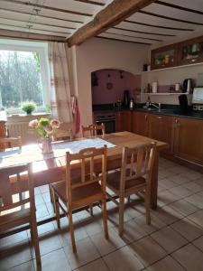 a kitchen with a wooden table and chairs and a table and a table at Le Wayai in Sart-lez-Spa