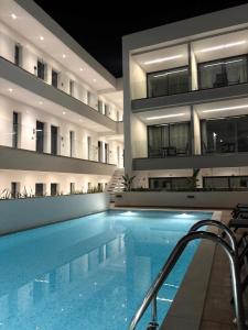 a swimming pool in front of a building at Diamond 2 in Kallithea Halkidikis